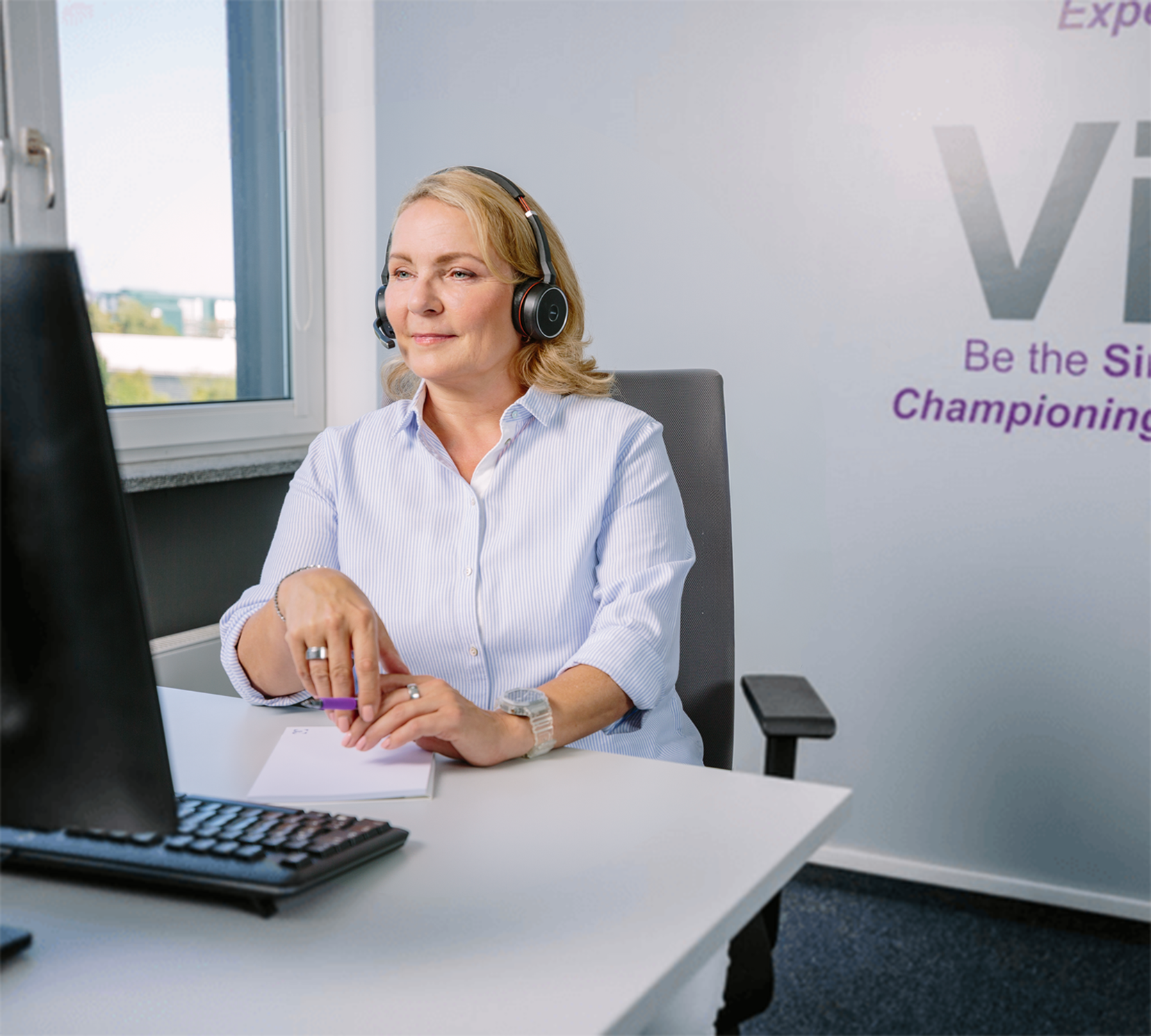 Picture of a UCBCares' employee on a call providing support